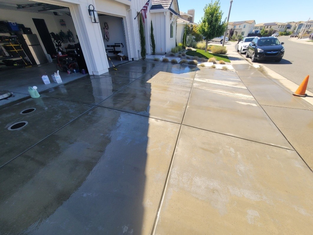 Wet concrete driveway after cleaning